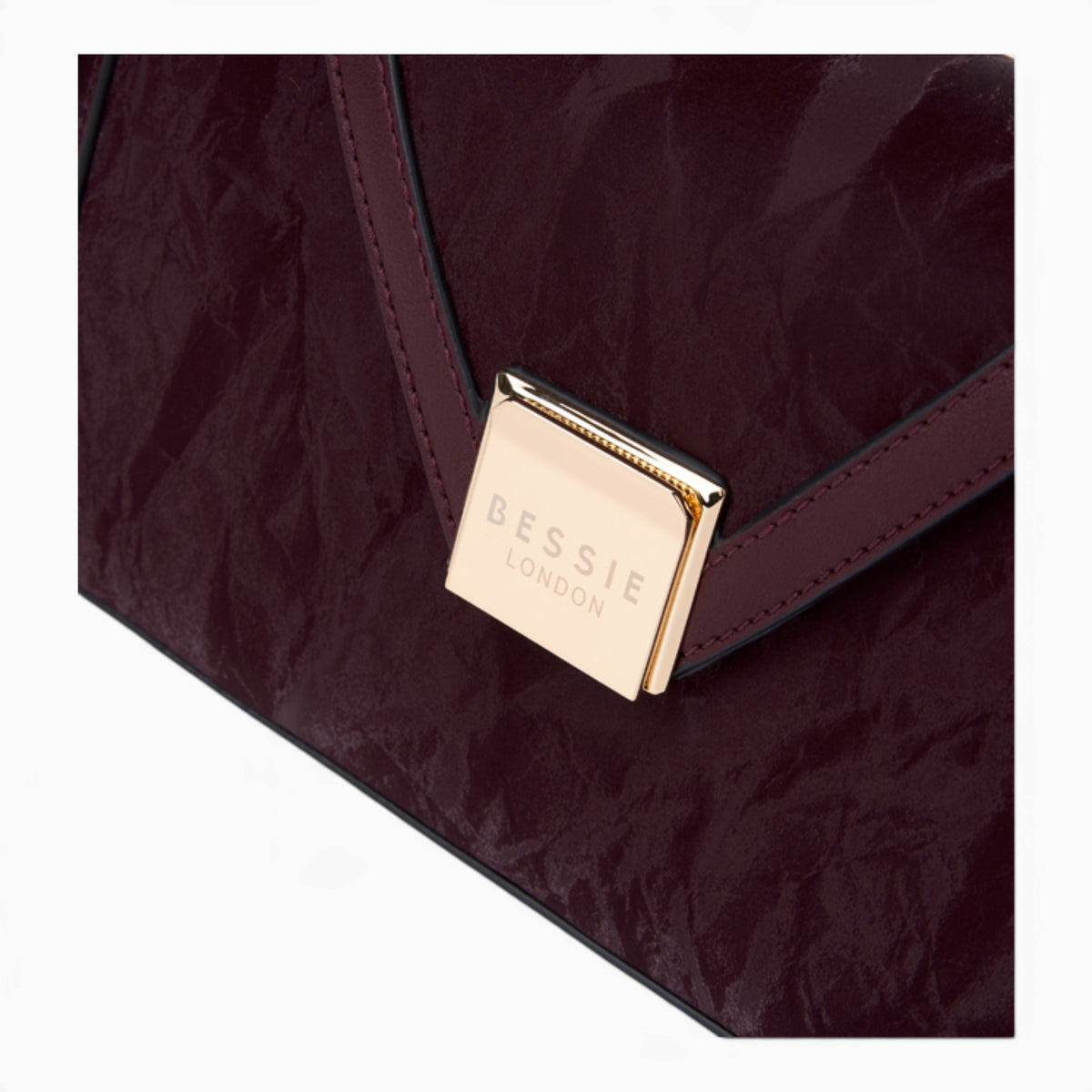 Wine velvet-effect underarm crossbody bag, close-up of the gold-tone clasp and velvet-effect finish