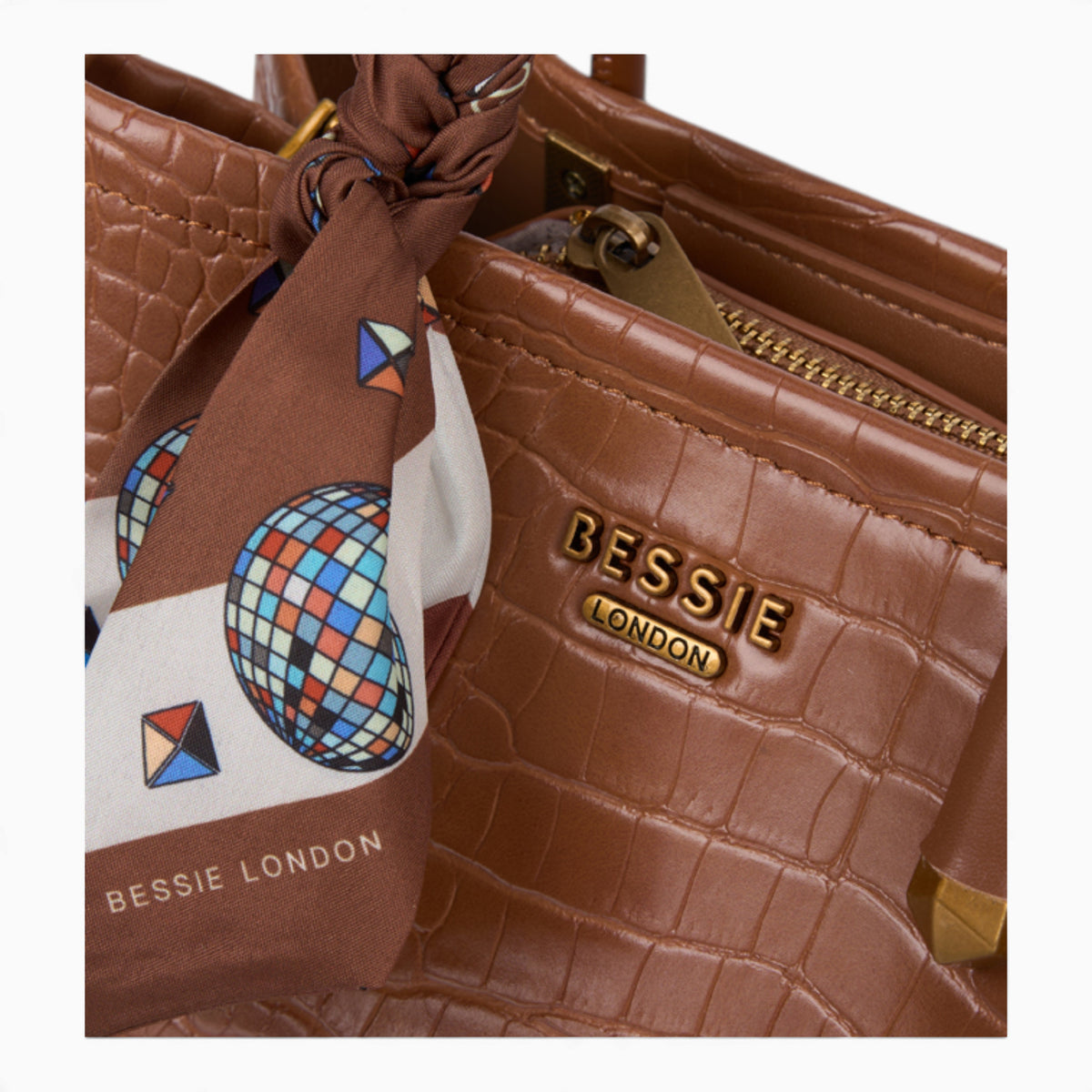 Tan croc-effect tote bag, close-up of the croc-effect texture and logo