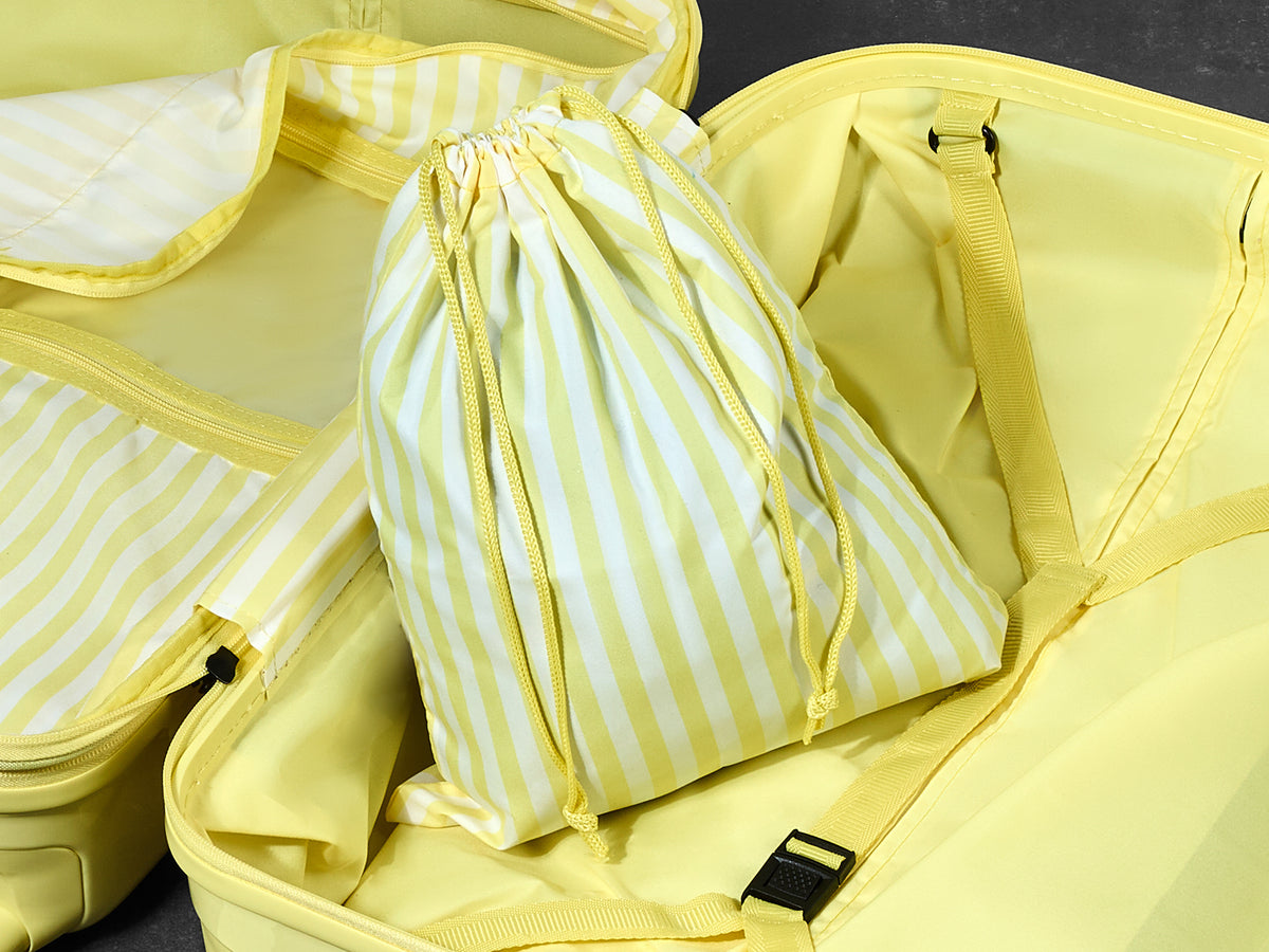 Lemon Ice Gelato suitcase, close-up of the matching striped laundry bag inside