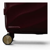 Burgundy Dusk Sahara suitcase, close-up of the 8 double spinner wheels