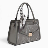 Grey velvet-effect flap tote bag, angled view showing the flap top and scarf