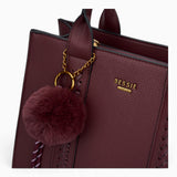 Wine pebble textured tote bag, close-up of the pom-pom charm and pebble texture