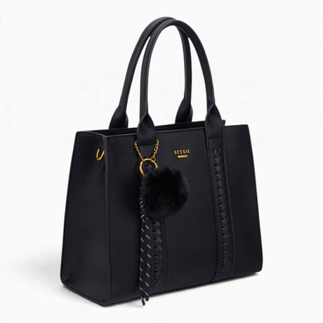 Black pebble textured tote bag, angled view showing the pebble texture and charm