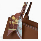 Tan minimalist everyday tote bag, close-up of the scarf tied to the handle