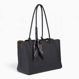 Grey knot handle shoulder bag, angled view showing the knot handle detail