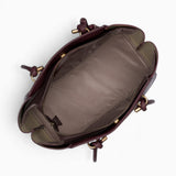 Wine knot handle shoulder bag opened to show the fully lined main compartment