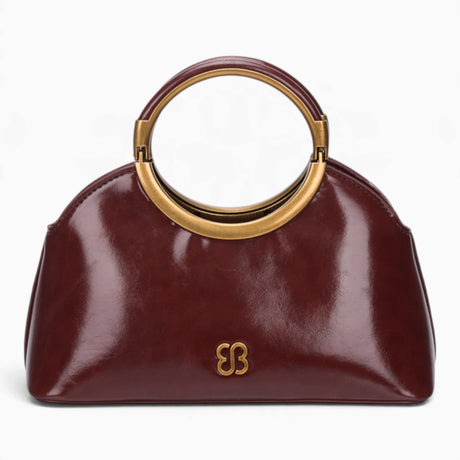 Wine ring handle crossbody bag with a gold ring handle and rounded shape