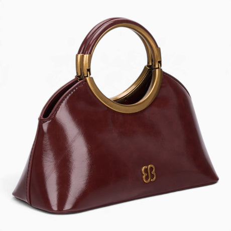 Wine ring handle crossbody bag, angled view showing the sculptural ring handle