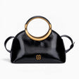 Black ring handle crossbody bag with a gold ring handle and rounded shape