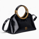Black ring handle crossbody bag, angled view showing the sculptural ring handle
