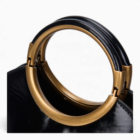 Black ring handle crossbody bag, close-up of the gold ring handle