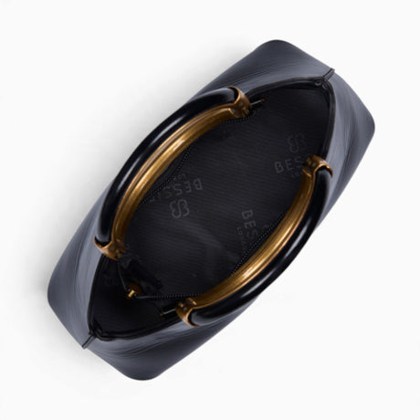 Black ring handle crossbody bag opened to show the fully lined interior and zip closure