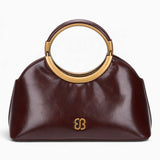 Coffee ring handle crossbody bag with a gold ring handle and rounded shape