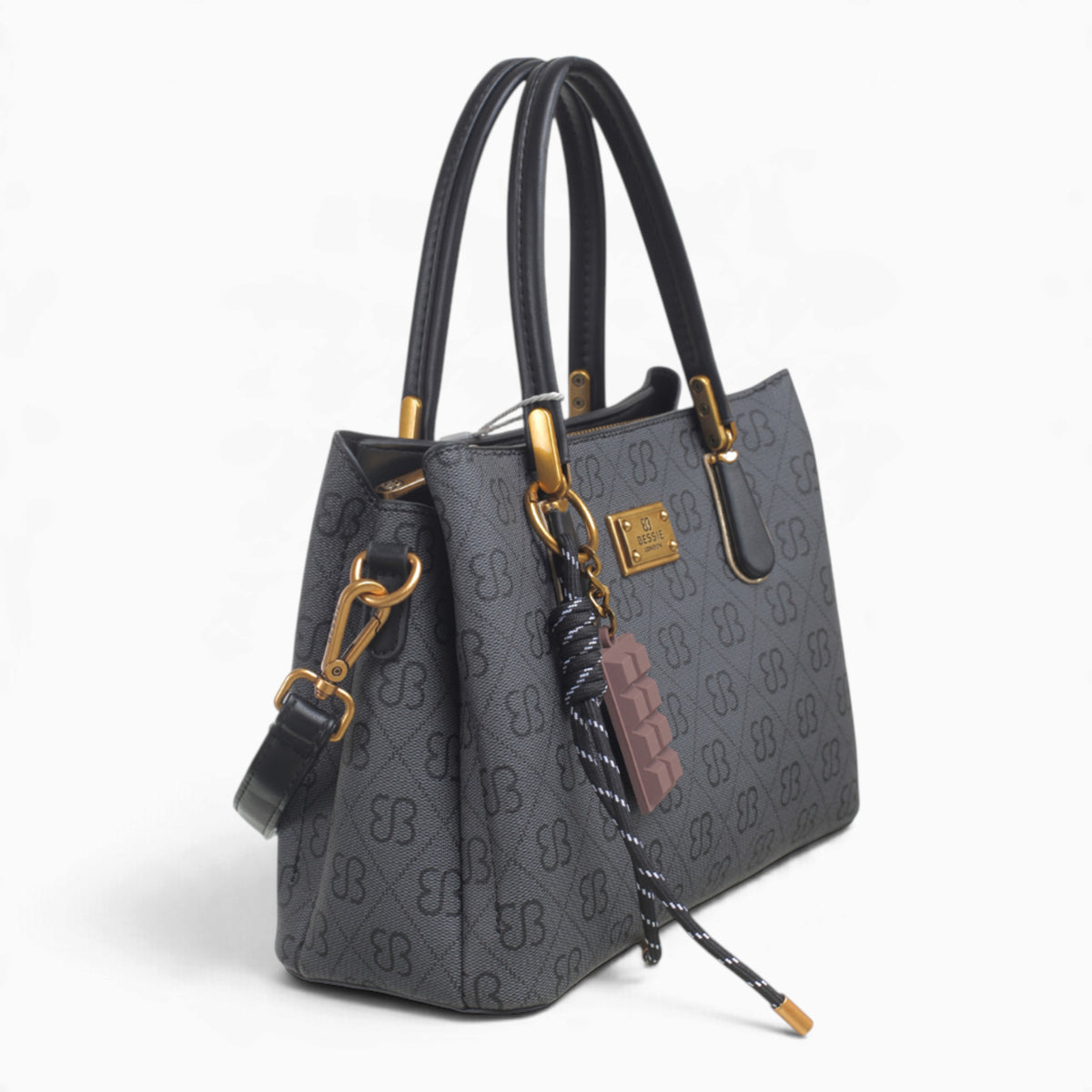 Black small monogram tote bag, angled view showing the monogram print and charm
