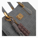 Grey small monogram tote bag, close-up of the charm and monogram print