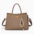 Tan monogram grab bag with a bag charm and double handles
