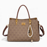 Tan monogram grab bag with a bag charm and double handles