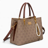Tan monogram grab bag, angled view showing the monogram print and charm