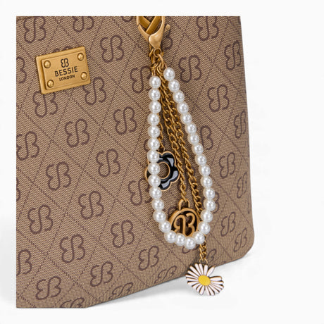 Tan monogram grab bag, close-up of the bag charm and monogram print