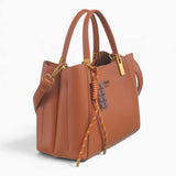 Tan faux leather tote bag, angled view showing the structured shape and charm