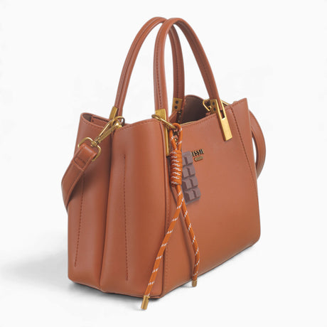 Tan faux leather tote bag, angled view showing the structured shape and charm