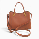 Tan faux leather tote bag with its detachable shoulder strap attached