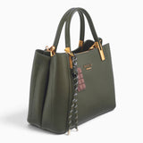 Dark green faux leather tote bag, angled view showing the structured shape and charm