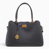 Black structured tote bag with a circular brand charm and gold-tone hardware