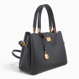 Black structured tote bag, angled view showing the structured shape and charm