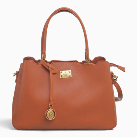 Tan structured tote bag with a circular brand charm and gold-tone hardware