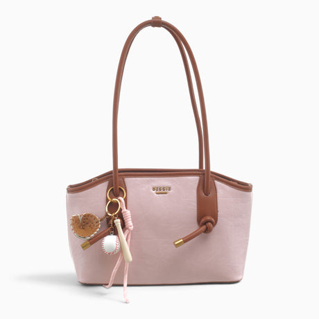 Pink knot shoulder bag with knotted straps and a novelty charm
