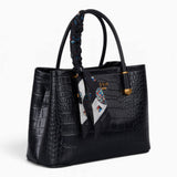 Black croc-effect tote bag, angled view showing the glossy croc-effect texture