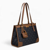 Black monogram shoulder bag, angled view showing the monogram print and charm
