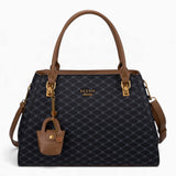 Black sculpted monogram tote bag with a charm and double handles