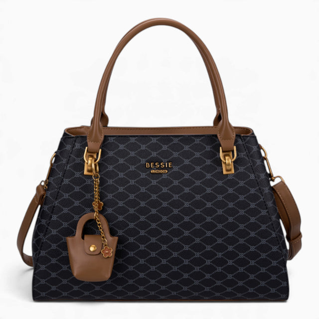 Black sculpted monogram tote bag with a charm and double handles