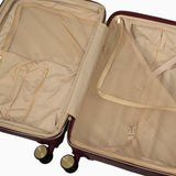 Burgundy Dusk Sahara suitcase opened to show the peach skin lining, mesh divider and packing straps