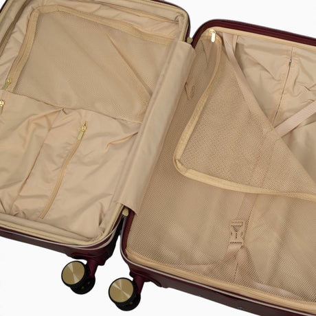 Burgundy Dusk Sahara suitcase opened to show the peach skin lining, mesh divider and packing straps