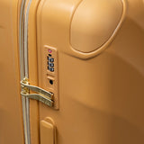 Gold Sunset Sahara suitcase, close-up of the TSA combination lock