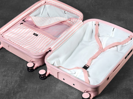 Strawberry Gelato suitcase opened to show the peach skin lining, wet pocket and packing straps