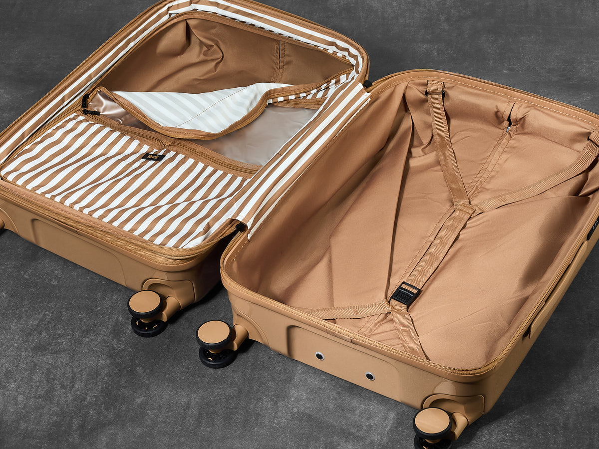 Chocolate Gelato suitcase opened to show the peach skin lining, wet pocket and packing straps