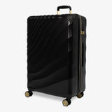 Moonlight Black Sahara large suitcase, angled view showing the wave-design shell