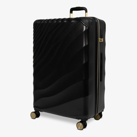 Moonlight Black Sahara large suitcase, angled view showing the wave-design shell