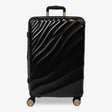Moonlight Black Sahara medium suitcase with a wave-design hard shell and 8 double spinner wheels