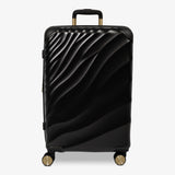 Moonlight Black Sahara medium suitcase with a wave-design hard shell and 8 double spinner wheels
