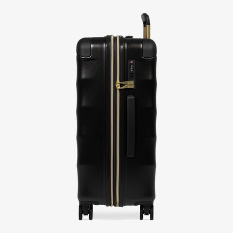 Moonlight Black Sahara medium suitcase, side view showing the side handle and reinforced corners
