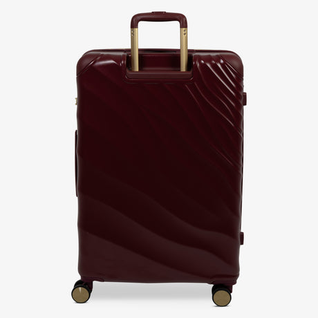 Burgundy Dusk Sahara large suitcase from the back, showing the trolley handle and back panel