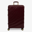 Burgundy Dusk Sahara large suitcase with a wave-design hard shell and 8 double spinner wheels