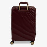 Burgundy Dusk Sahara medium suitcase from the back, showing the trolley handle and back panel