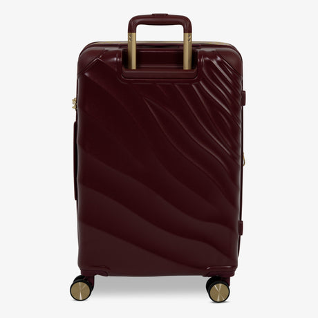 Burgundy Dusk Sahara medium suitcase from the back, showing the trolley handle and back panel