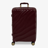 Burgundy Dusk Sahara medium suitcase with a wave-design hard shell and 8 double spinner wheels
